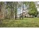 Enjoy the peaceful backyard surrounded by mature trees at 1335 Saint Andrews Dr, Mebane, NC 27302