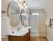 Bathroom featuring dual sinks, updated shower, and tile flooring at 1335 Saint Andrews Dr, Mebane, NC 27302