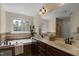 Well-lit bathroom with a soaking tub, dual vanity, and a large mirror at 1335 Saint Andrews Dr, Mebane, NC 27302