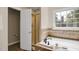 Bathroom featuring a soaking tub, a window, and a separate gold-framed shower stall at 1335 Saint Andrews Dr, Mebane, NC 27302