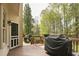 The wooden deck features a grill with a cover and an entrance to the home's interior at 1335 Saint Andrews Dr, Mebane, NC 27302