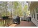 Enjoy outdoor living on this wooden deck with an umbrella-covered picnic table and gas grill at 1335 Saint Andrews Dr, Mebane, NC 27302