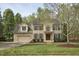 Charming two-story brick home featuring a front yard, manicured landscaping and a welcoming front entrance at 1335 Saint Andrews Dr, Mebane, NC 27302