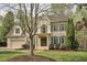 Charming two-story brick home featuring manicured landscaping and a welcoming front entrance at 1335 Saint Andrews Dr, Mebane, NC 27302