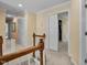 Hallway with carpet and wood railing, leading to bedrooms and closets at 1335 Saint Andrews Dr, Mebane, NC 27302