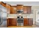 Kitchen features stainless steel appliances, dark cabinets, and hardwood floors at 1335 Saint Andrews Dr, Mebane, NC 27302