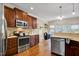 A kitchen with stainless steel appliances and dark wood cabinets at 1335 Saint Andrews Dr, Mebane, NC 27302