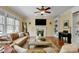The inviting living room features a fireplace, hardwood floors, and a comfortable couch at 1335 Saint Andrews Dr, Mebane, NC 27302