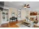 Inviting living room featuring hardwood floors, a ceiling fan, and built-in shelving at 1335 Saint Andrews Dr, Mebane, NC 27302