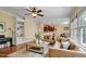 Spacious living room boasts hardwood floors, a ceiling fan, and a comfortable seating arrangement at 1335 Saint Andrews Dr, Mebane, NC 27302