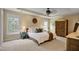 The main bedroom has plush carpet, a ceiling fan, and a side table at 1335 Saint Andrews Dr, Mebane, NC 27302