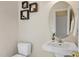 The half bathroom features neutral walls, a small vanity, and an oval mirror at 1335 Saint Andrews Dr, Mebane, NC 27302