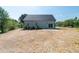 View of the backyard featuring a sliding glass door and a concrete patio at 1394 Delma Grimes Rd, Coats, NC 27521