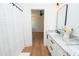 Bathroom featuring double vanity, granite counters, modern fixtures, and shower at 1394 Delma Grimes Rd, Coats, NC 27521