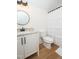 Inviting bathroom features modern vanity, shower with curtain, and natural-look flooring at 1394 Delma Grimes Rd, Coats, NC 27521