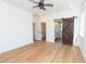 Bright bedroom featuring hardwood floors, ceiling fan, closet, and vanity at 1394 Delma Grimes Rd, Coats, NC 27521