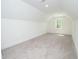 Spacious room with soft carpeting, a window for natural light, and angled ceiling at 1394 Delma Grimes Rd, Coats, NC 27521