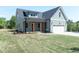Charming home featuring a two-car garage and well-manicured lawn at 1394 Delma Grimes Rd, Coats, NC 27521