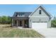 Charming home featuring a two-car garage and well-manicured lawn at 1394 Delma Grimes Rd, Coats, NC 27521