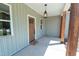 Cozy front porch featuring stylish lighting and a warm welcome mat at 1394 Delma Grimes Rd, Coats, NC 27521