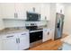 Modern kitchen featuring stainless steel appliances and white cabinets at 1394 Delma Grimes Rd, Coats, NC 27521