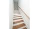 Wooden staircase with white risers and a light wood handrail leads to the upper level at 1394 Delma Grimes Rd, Coats, NC 27521
