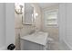 Vanity with marble countertop, toilet, and a shower with white tile at 1410 Cross Link Rd, Raleigh, NC 27610