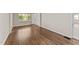 Bright bedroom featuring gleaming hardwood floors and a sunlit window with charming views at 1410 Cross Link Rd, Raleigh, NC 27610
