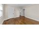 A bedroom with hardwood floors and doorways to other rooms at 1410 Cross Link Rd, Raleigh, NC 27610