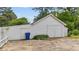 Spacious detached garage with white siding, double doors, and a convenient side entrance at 1410 Cross Link Rd, Raleigh, NC 27610