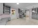View of the kitchen with gray cabinets, an island, tile floor, and doorway leading to another room at 1410 Cross Link Rd, Raleigh, NC 27610
