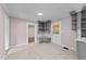 View of the kitchen with gray cabinets, an island, tile floor, and doorway leading to another room at 1410 Cross Link Rd, Raleigh, NC 27610