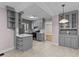 Stylish gray kitchen with updated appliances, modern cabinetry, and neutral tile flooring at 1410 Cross Link Rd, Raleigh, NC 27610