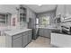 Updated gray kitchen with stainless steel appliances, white subway tile backsplash, and tile flooring at 1410 Cross Link Rd, Raleigh, NC 27610