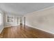 Spacious living room with hardwood floors, neutral walls, white trim, and glass paneled french doors at 1410 Cross Link Rd, Raleigh, NC 27610