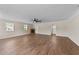 Open-concept living room with hard surface floors, a ceiling fan, and views of the home's exterior at 1410 Cross Link Rd, Raleigh, NC 27610