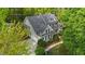 Stunning aerial view of a charming home with a private driveway, a well-kept lawn, and mature trees surrounding the property at 144 W Walker Woods Ln, Clayton, NC 27527