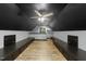 Finished attic space with dark painted ceiling and custom cabinets along the walls at 144 W Walker Woods Ln, Clayton, NC 27527