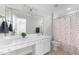 Bathroom with a large white sink vanity and a shower with a multicolored curtain at 144 W Walker Woods Ln, Clayton, NC 27527