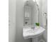 Bathroom with pedestal sink, vanity mirror, and overhead storage at 144 W Walker Woods Ln, Clayton, NC 27527