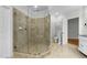 Bathroom with walk-in shower, neutral tile, and built-in shower bench at 144 W Walker Woods Ln, Clayton, NC 27527
