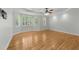 Spacious bedroom with hardwood floors, tray ceiling, and large windows at 144 W Walker Woods Ln, Clayton, NC 27527