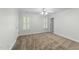 Bedroom with neutral carpet, white trim, ceiling fan, and two windows with white shutters at 144 W Walker Woods Ln, Clayton, NC 27527