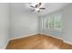 Cozy bedroom with hardwood flooring, ceiling fan, and a bright window at 144 W Walker Woods Ln, Clayton, NC 27527
