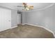 Bedroom with neutral carpet, gray walls, white trim, ceiling fan, and white door at 144 W Walker Woods Ln, Clayton, NC 27527