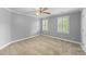 Bedroom with neutral carpet, gray walls, white trim, and two windows with white shutters at 144 W Walker Woods Ln, Clayton, NC 27527