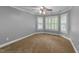 Bedroom with neutral carpet, gray walls, white trim, ceiling fan, and windows at 144 W Walker Woods Ln, Clayton, NC 27527