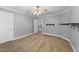 Bedroom with neutral carpet, gray walls, white trim, ceiling fan, and open door at 144 W Walker Woods Ln, Clayton, NC 27527
