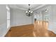 Bright dining room featuring hardwood floors, decorative chandelier, and detailed trim work at 144 W Walker Woods Ln, Clayton, NC 27527