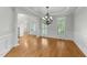 Elegant dining room with hardwood floors, chandelier, and arched doorway at 144 W Walker Woods Ln, Clayton, NC 27527